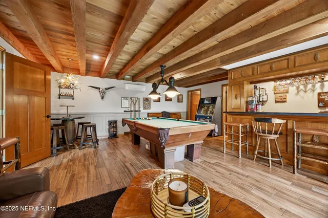 a view of a patio with table and chairs with wooden fence