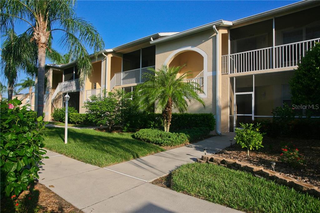 5270 Hyland Hills Avenue, Unit 1722 Sarasota, FL 34241 - Photo 11 of 30 a front view of a house with garden