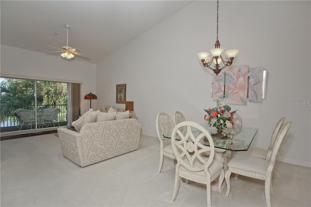 5270 Hyland Hills Avenue, Unit 1722 Sarasota, FL 34241 - Photo 15 of 30 a living room with furniture chandelier and a chandelier