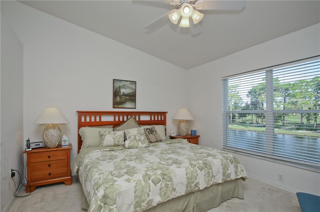 5270 Hyland Hills Avenue, Unit 1722 Sarasota, FL 34241 - Photo 23 of 30 a bedroom with a bed and a large window