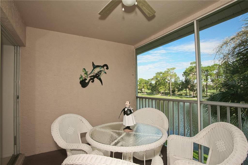 5270 Hyland Hills Avenue, Unit 1722 Sarasota, FL 34241 - Photo 27 of 30 a table and chairs in a balcony