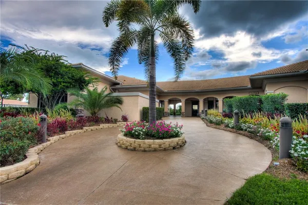 a front view of a house with a garden and a patio