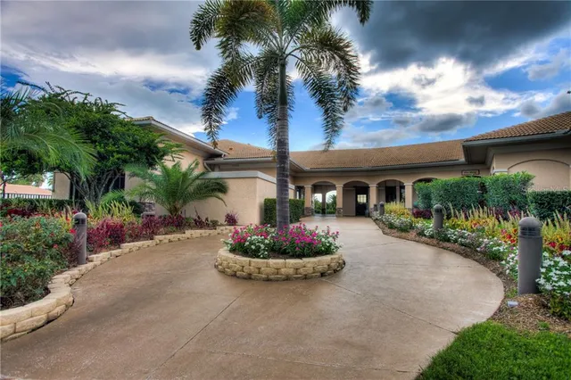 a front view of a house with a garden and a patio
