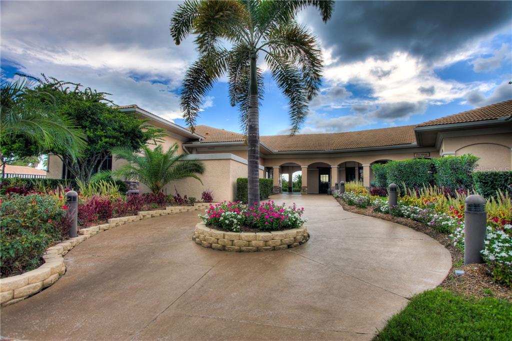 5270 Hyland Hills Avenue, Unit 1722 Sarasota, FL 34241 - Photo 5 of 30 a front view of a house with a garden and a patio