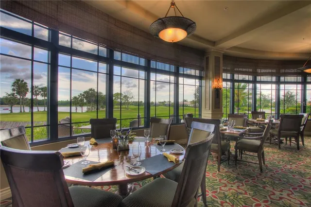 a view of a dining room with furniture large windows and wooden floor