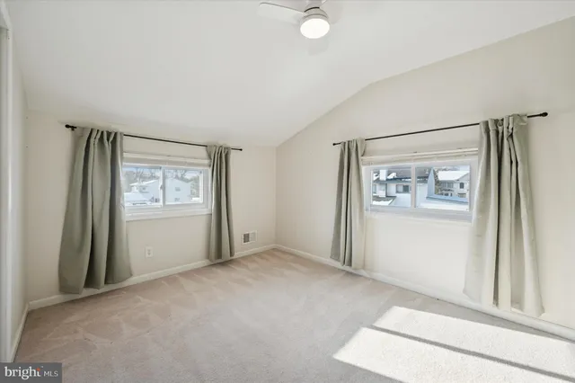 an empty room with windows and closet