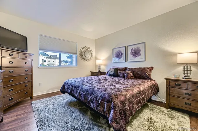 a bedroom with a bed and a television