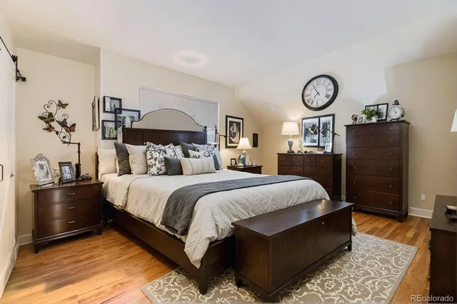 a bedroom with a large bed and a chandelier