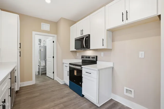 a kitchen with a stove a refrigerator and a sink