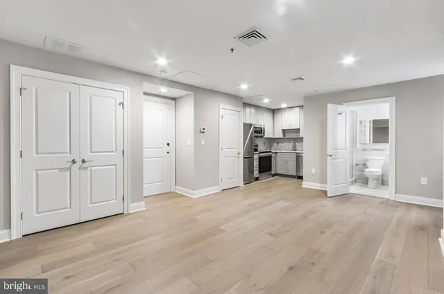 a view of a kitchen with a refrigerator a sink and dishwasher cabinets