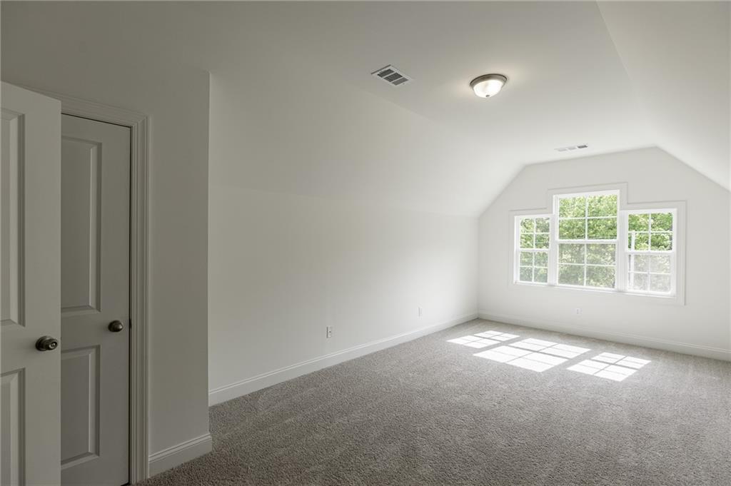 1210 Austin Road Winder, GA 30680 - Photo 46 of 56 a view of a big room with windows and chandelier fan