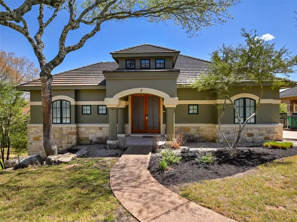 a front view of a house with a yard