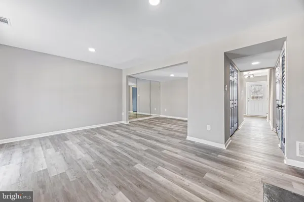 a view of empty room with wooden floor