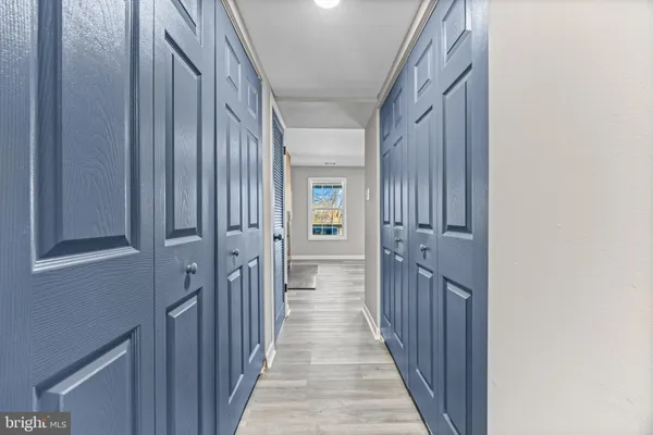 a view of a hallway with wooden floor and staircase