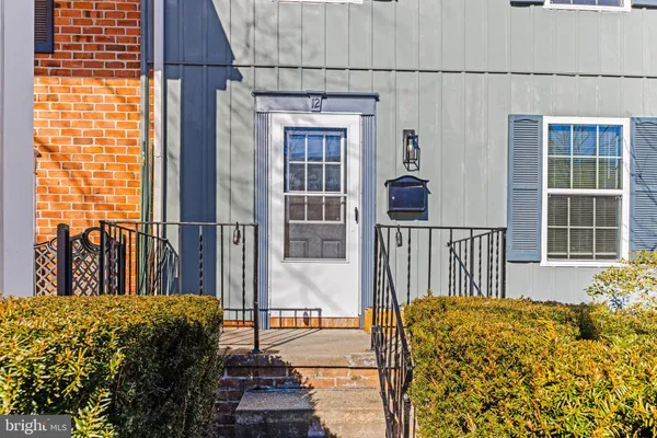 a bed sitting in front of a house with wooden floor