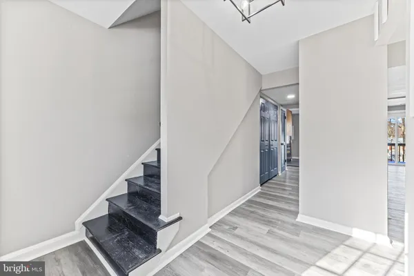 a view of entryway and hall with wooden floor