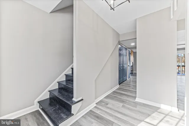a view of entryway and hall with wooden floor