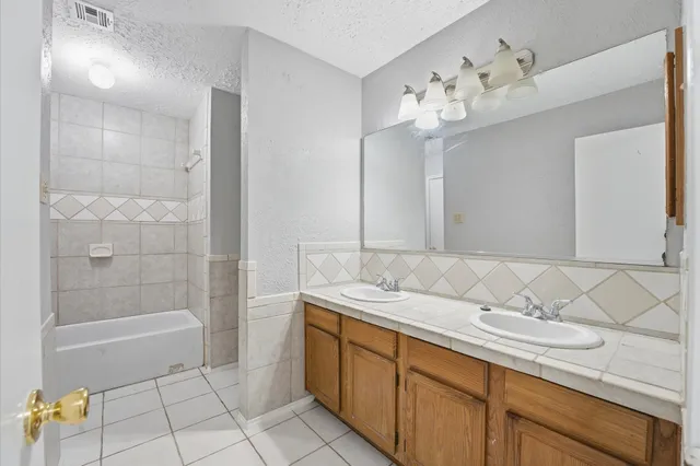 a bathroom with a sink a vanity and a mirror