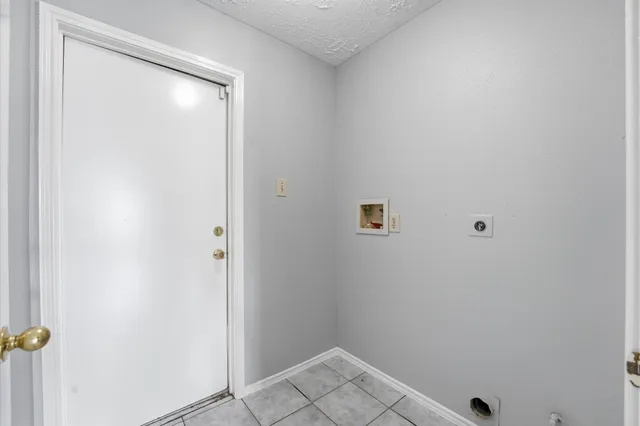 a large kitchen with a stove a sink dishwasher a refrigerator and a stove with wooden floor