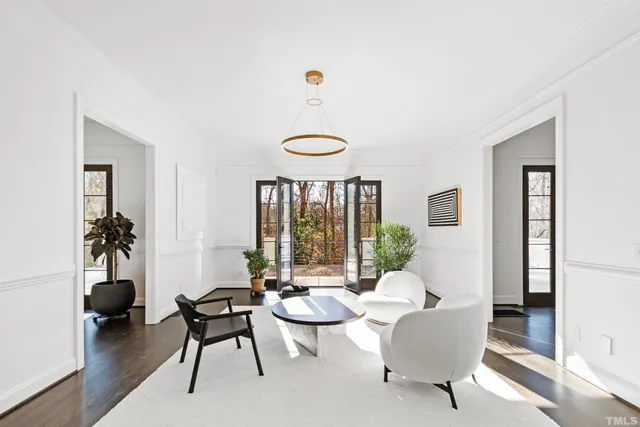 a kitchen that has a lot of cabinets a sink and wooden floor