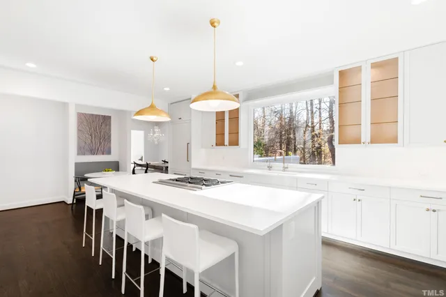 a living room with furniture or couches and a large mirror with wooden floor