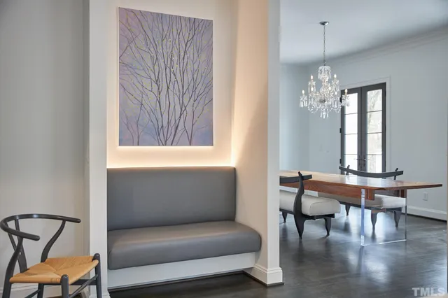 a living room with furniture a rug a fireplace and a large window