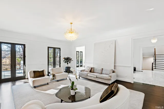 a bedroom with a large bed and a chandelier