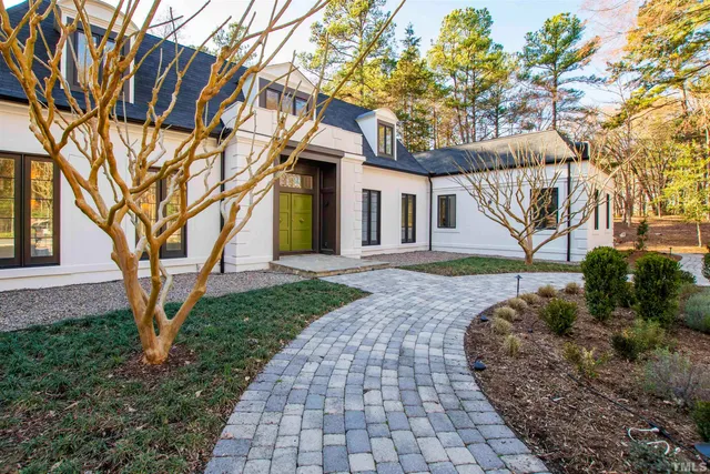 a view of an empty room with stairs and a couch