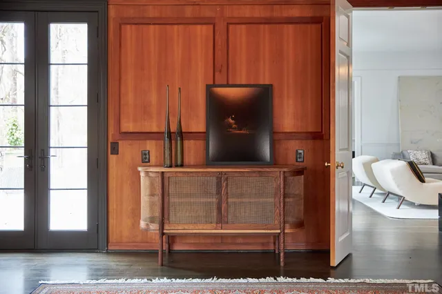 a view of living room with a floor to ceiling window and potted plants