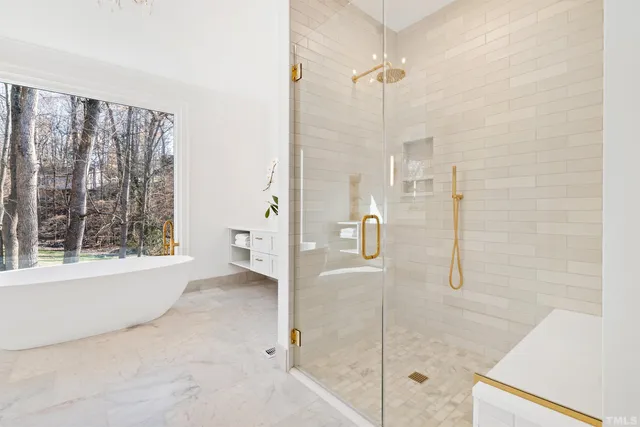 a front view of a house with garden and trees