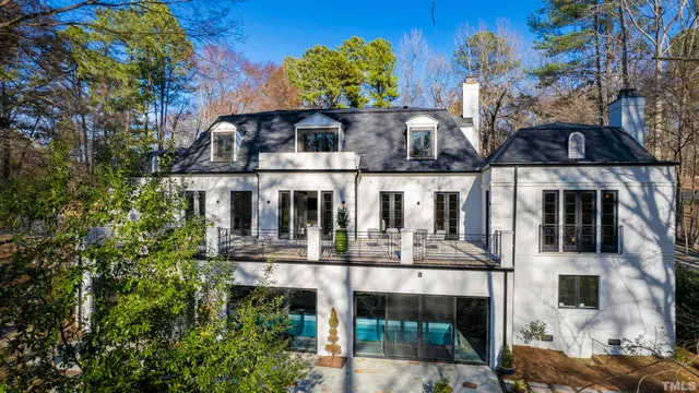a living room with furniture a lamp and a potted plant