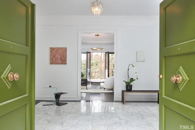 a dining room with furniture a chandelier and wooden floor