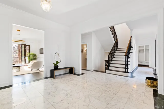 a kitchen with a stove a sink a center island and a wooden floor