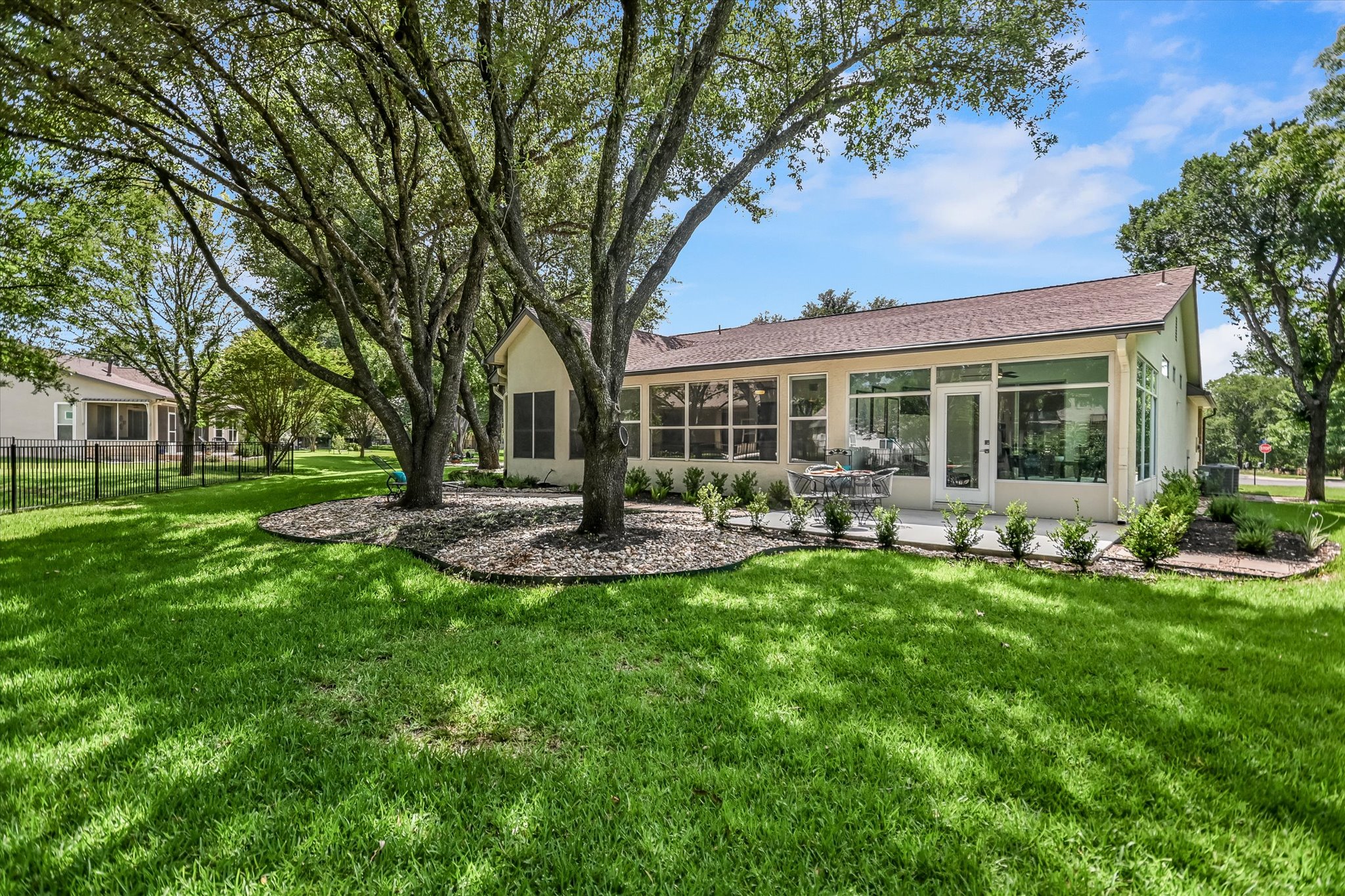 105 Stetson Circle Georgetown, TX 78633 - Photo 19 of 21 A view of the back of the house featuring the lush green lawn and shade trees that draw you in and invite you to sit and relax!