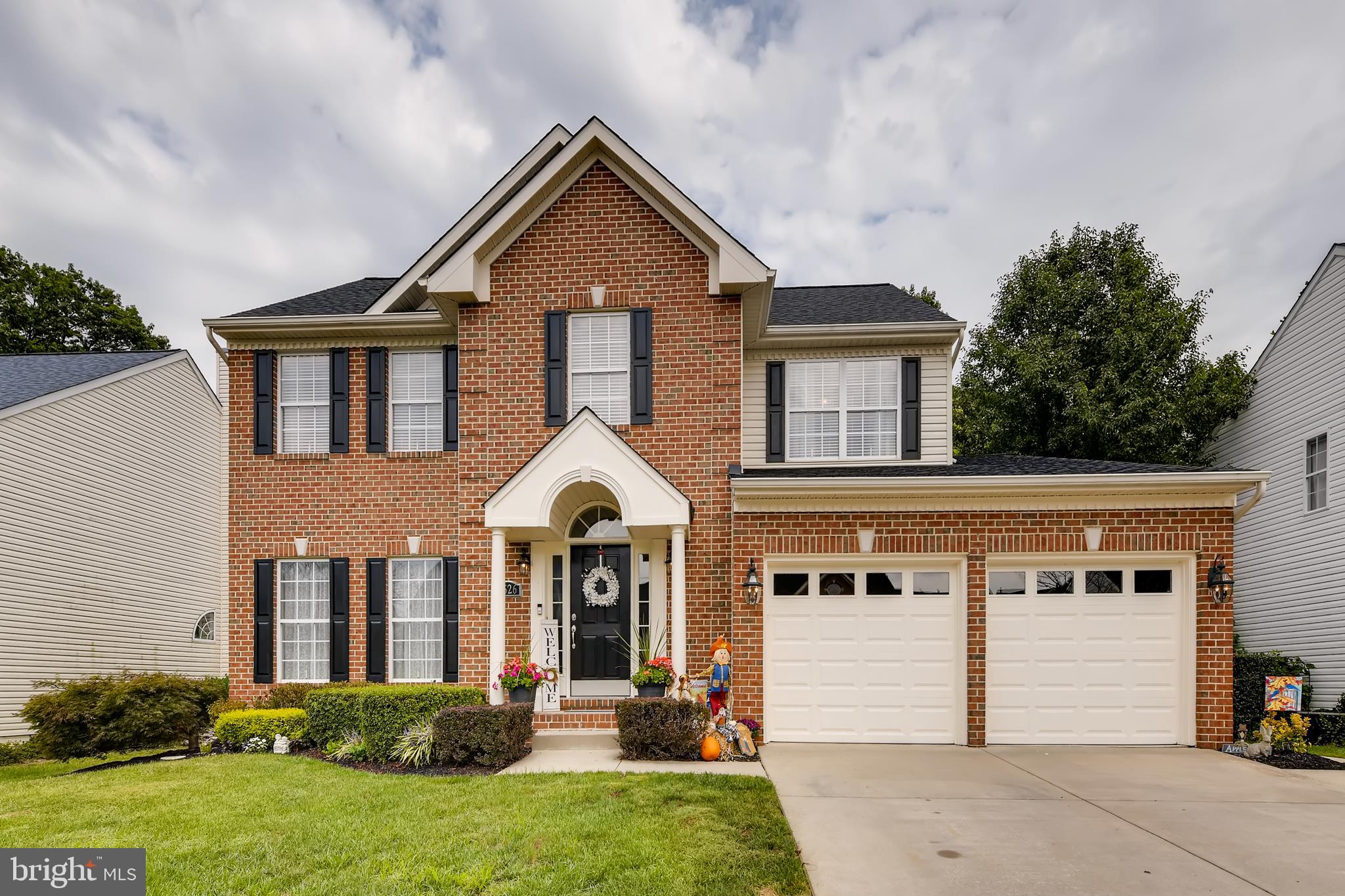 9526 Good Spring Drive Perry Hall, MD 21128 - Photo 1 of 42 a front view of a house with garden