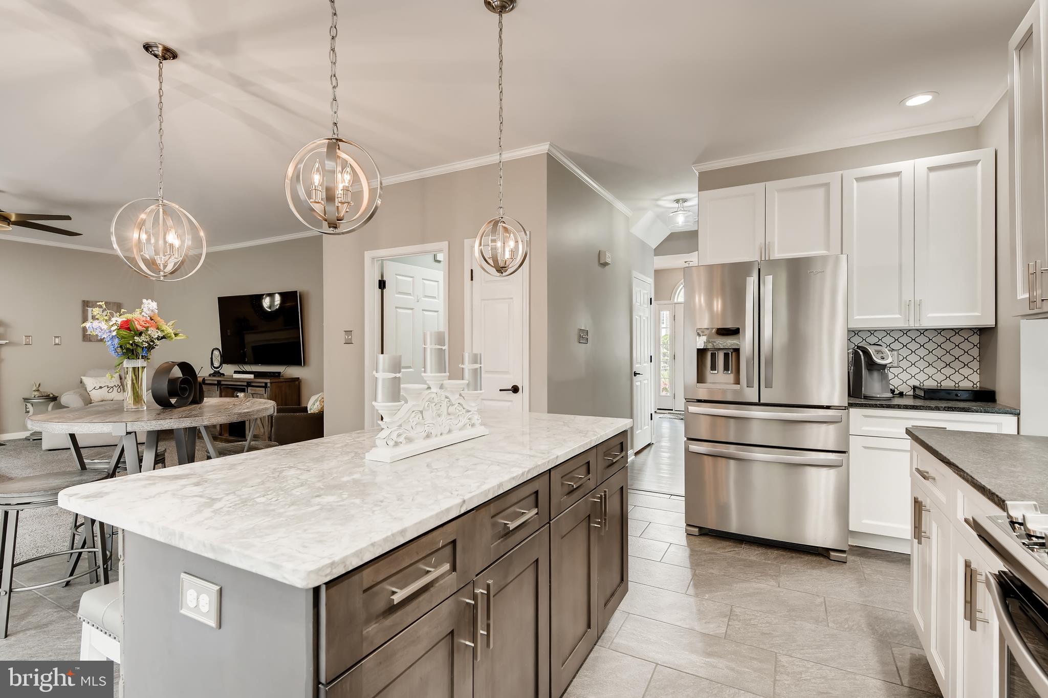 9526 Good Spring Drive Perry Hall, MD 21128 - Photo 12 of 42 a kitchen with stainless steel appliances a stove a sink island a refrigerator and chairs