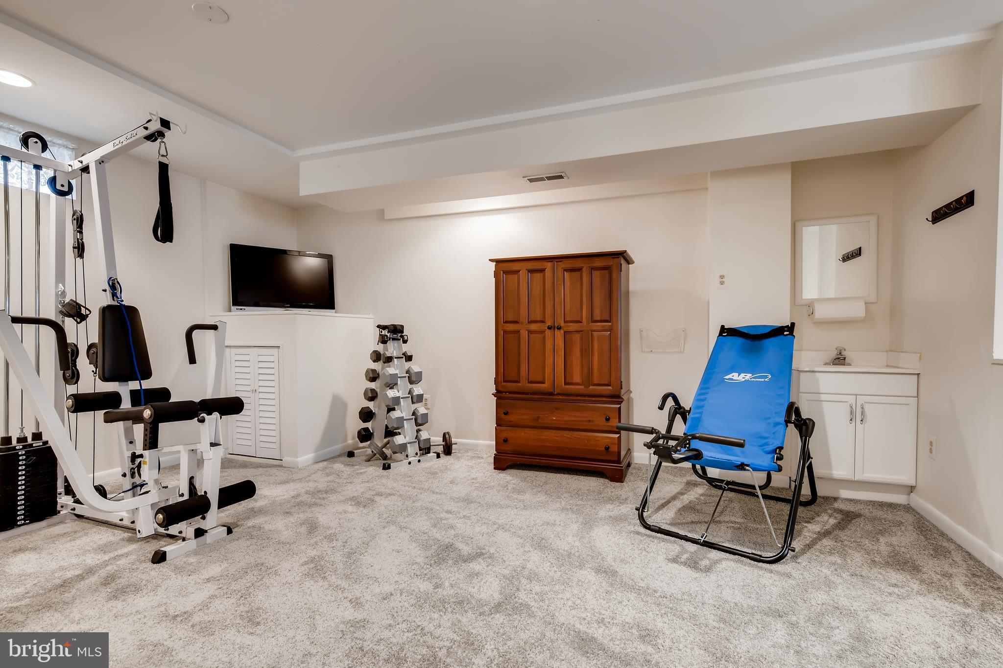 9526 Good Spring Drive Perry Hall, MD 21128 - Photo 30 of 42 a room with gym equipment and a flat screen tv