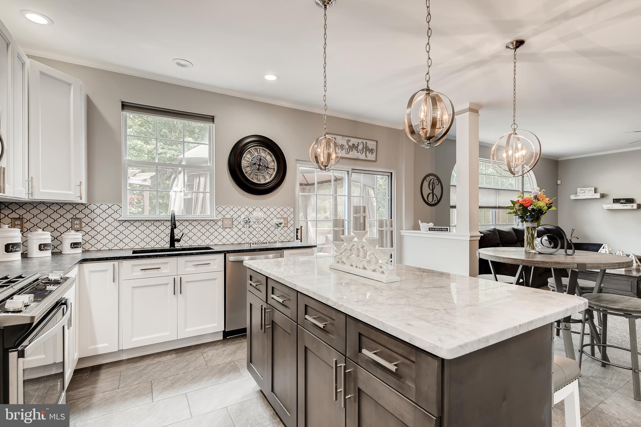 9526 Good Spring Drive Perry Hall, MD 21128 - Photo 8 of 42 a kitchen with kitchen island white cabinets and stainless steel appliances