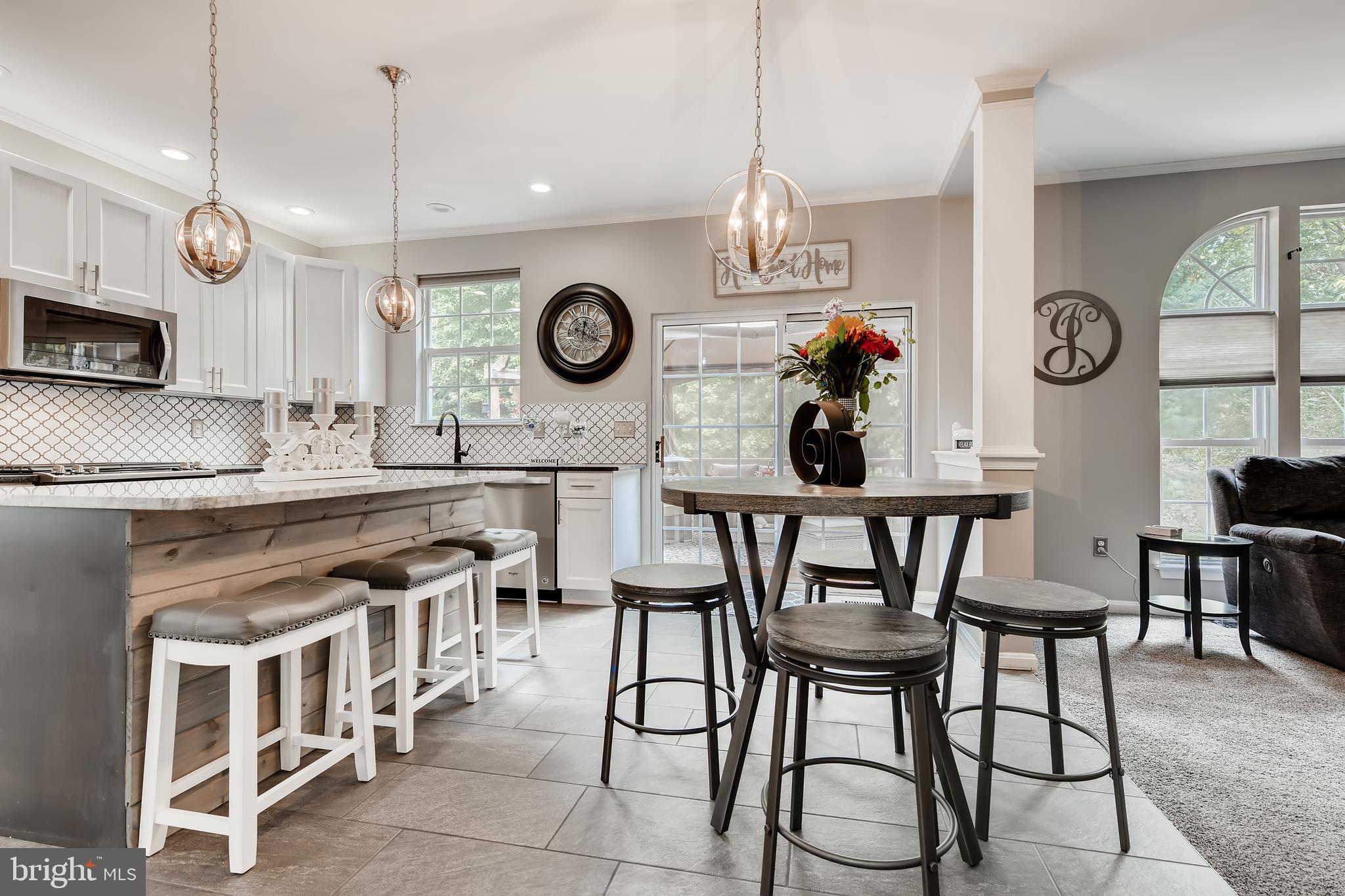9526 Good Spring Drive Perry Hall, MD 21128 - Photo 10 of 42 a kitchen with a table chairs and a clock on it
