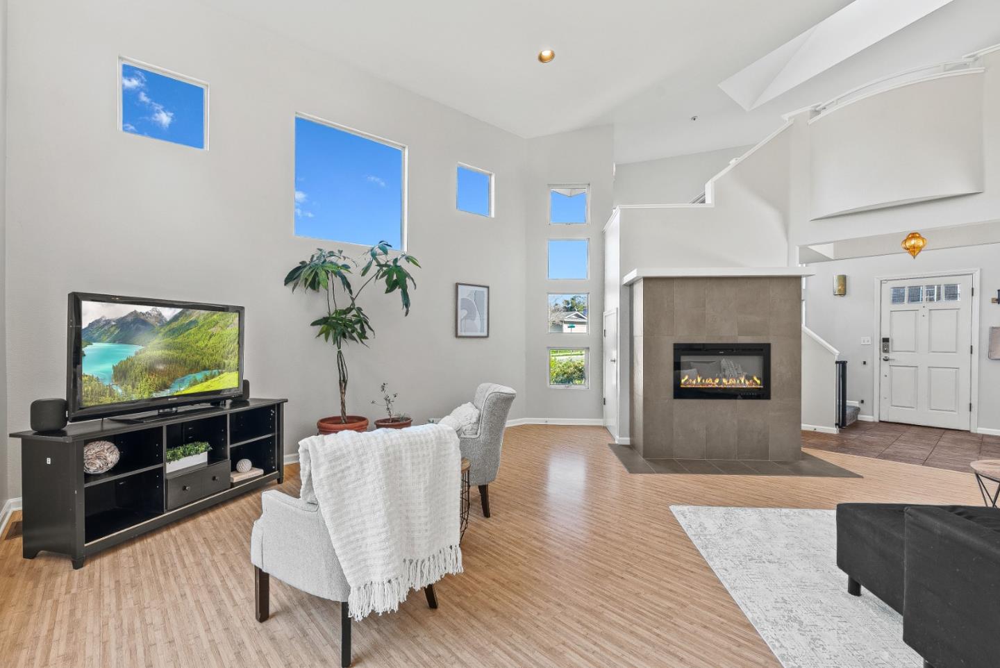 3200 Axford Road Santa Cruz, CA 95062 - Photo 11 of 45 a living room with furniture a flat screen tv and a fireplace