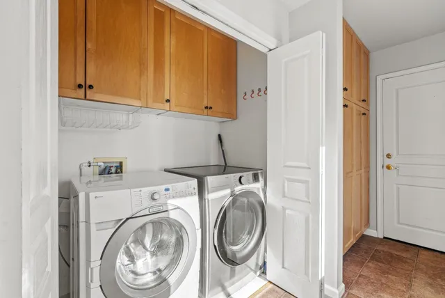 a view of a hallway to closet and utility room