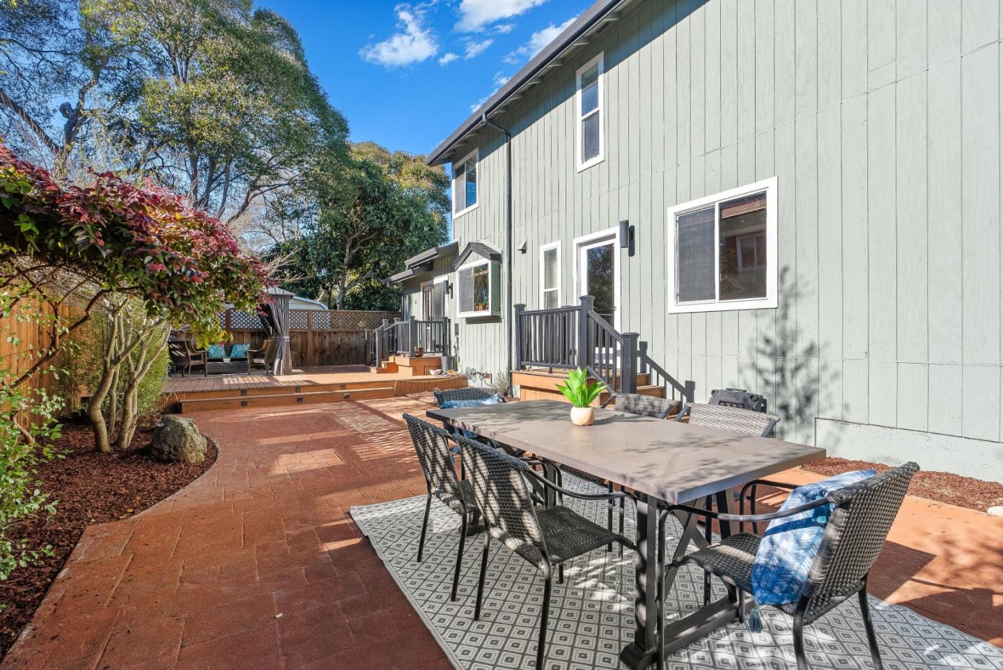 3200 Axford Road Santa Cruz, CA 95062 - Photo 38 of 45 a view of a patio with table and chairs with wooden fence and plants