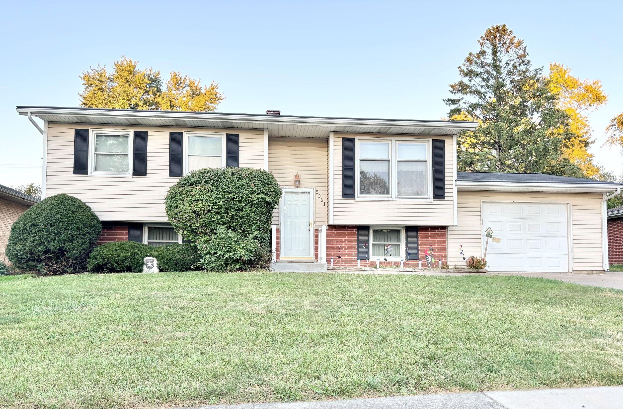 front view of a house next to a yard