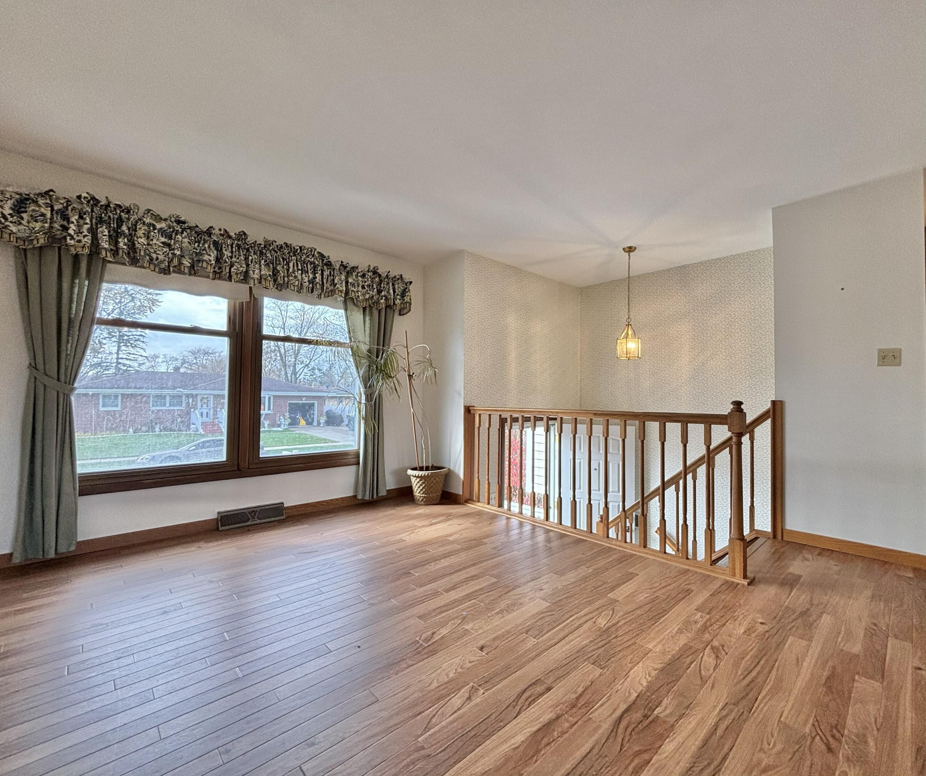 5361 Pierce Street Merrillville, IN 46410 - Photo 4 of 21 wooden floor in an empty room with a window