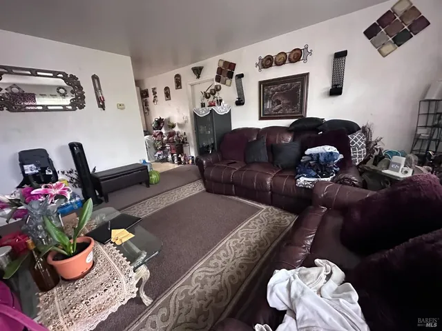 a living room with furniture and flowers
