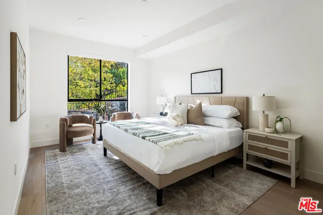 a bedroom with a bed and a couch