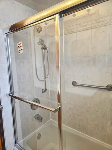a bathroom with a glass shower door