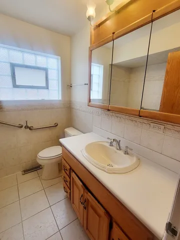 a bathroom with a sink a toilet and mirror