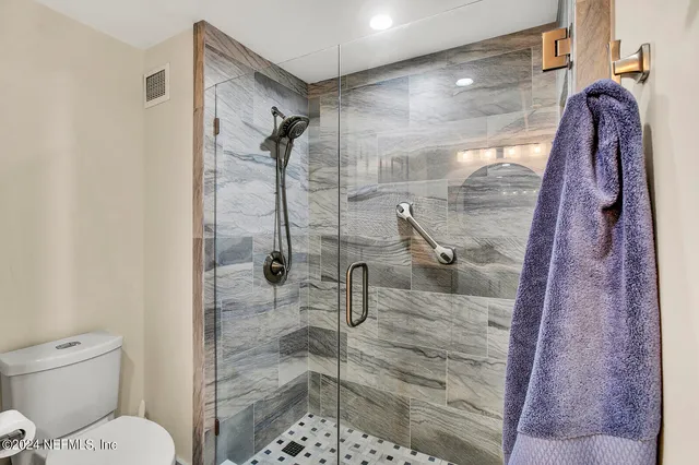a bathroom with a shower and toilet