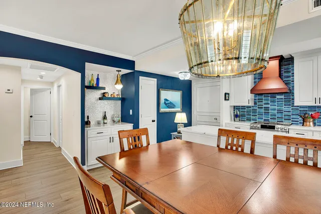 a living room with fireplace furniture and a chandelier